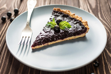 Homemade summer berry tart on a wooden background