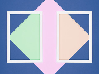 Abstract geometrical blue, pink and green paper flat lay background. Minimalism, geometry and symmetry template with empty picture frame mock up.