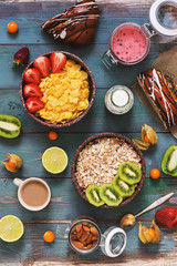 Fototapeta na wymiar Healthy Breakfast with cereals, fruits,berries, coffee on a blue rustic wooden background. The view from the top,flat lay