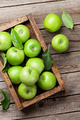Green apples in wooden box