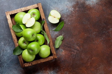 Green apples in wooden box