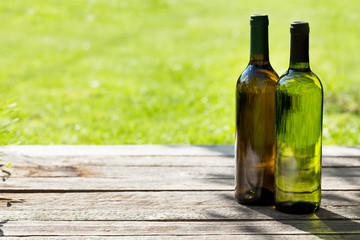 White wine bottles on wooden table