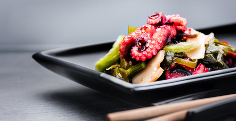 Japanese salad with octopus and ginger. Healthy food. Seafood closeup