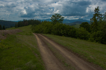 Fototapeta na wymiar dirt road going to the Carpathian Mountains