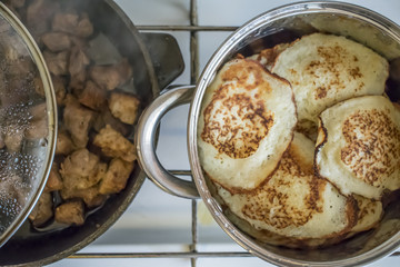 Traditional Russian pancake pancake on a cast-iron frying pan