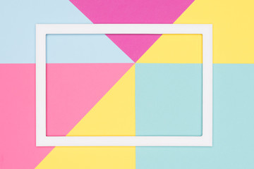 Fototapeta na wymiar Abstract geometry flat lay pastel blue, pink and yellow paper texture minimalism background. Minimal geometric shapes and lines template with empty picture frame mock up.