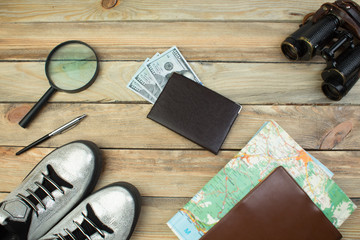 Travel accessories costumes. Passports, luggage, The cost of travel maps prepared for the trip. Top view image of travel accessories with washed out vintage filter effect.