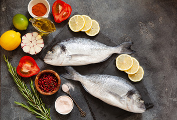 Raw dorado fish with spices on cutting board