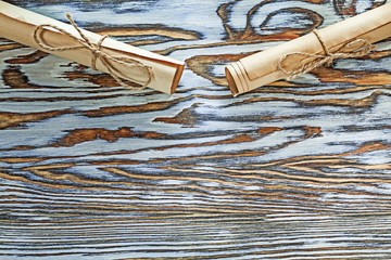 Vintage corded paper scrolls on wooden board