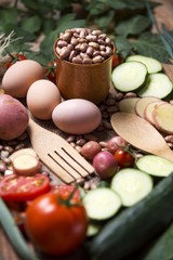 Fototapeta na wymiar Food table with beans, eggs, tomato, potato and cucumber.