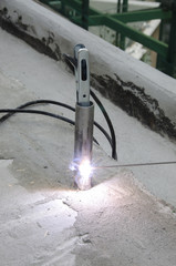 welds of a railing during the renovation of a roof in the evening in Italy