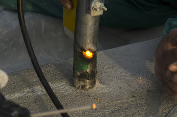 welds of a railing during the renovation of a roof in the evening in Italy