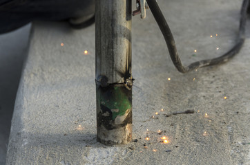 welds of a railing during the renovation of a roof in the evening in Italy