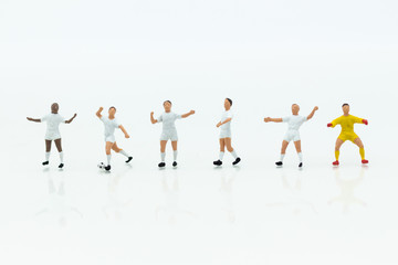 Fototapeta na wymiar Miniature people : Football team image use for football of the year, world cup , sport concept.