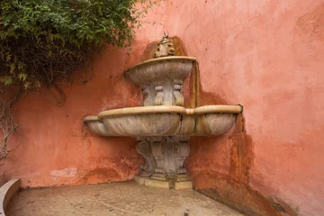 Papier Peint photo Fontaine Seville. An old antique fountain hidden in one of the alleys of the old city