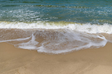 Wave of sea water and sand.