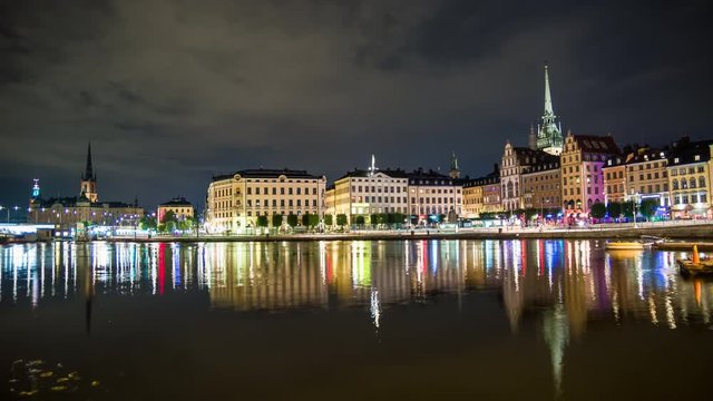 4K Time Lapse of Stockholm Old Town buildings. Gamla stan cityscape skyline at night, beautiful water reflections. Capital city of Sweden