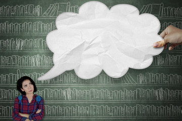 Pensive college student looking at cloud bubble