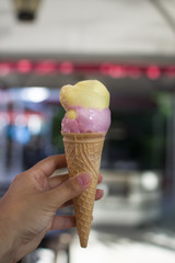 strawberry and lemon flavored ice cream in hands
