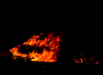 burning car on the road at night, a tragic accident ending with the ignition of a car
