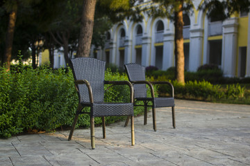Fototapeta na wymiar wicker straw chairs in the yard