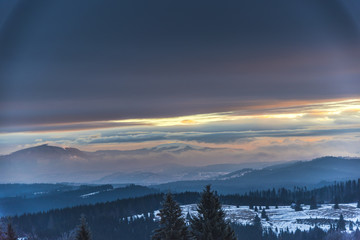 Fantastic colors of clouds at the sunset in Carpathians Mountains