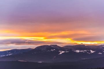 Fantastic colors of clouds at the sunset in Carpathians Mountains