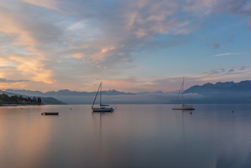 Colorful sunrise on the marina of Lausanne on the Lake Leman in summer with the view of the Swiss Alps in background - 18