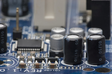 Electronic board. The board features elements: chips, diodes, capacitors, chokes. Shallow depth of...