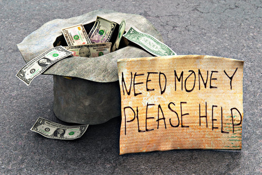 Beggar's hat with money on the street