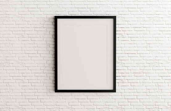 Blank black picture frame template for place image or text inside on white brick wall.