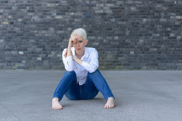 Depressed woman sitting on the ground
