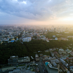 Panoramic view of a modern city at sunset. Skyline bird eye aerial view of the old part of the city under dramatic cloud sunset sky. Pochtovaya square, Vladimirskaya Gorka, St. Andrew's Church, St