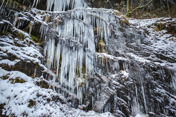 Fototapeta na wymiar Winter icicles on the stone