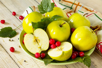 Homemade canning. Pickles apples with cranberries on the kitchen table in a rustic style.