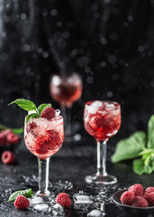 Fresh raspberry cocktail. Fresh summer cocktail with raspberry and ice cubes. Glass of raspberry mojito