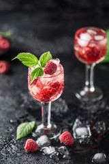 Fresh raspberry cocktail. Fresh summer cocktail with raspberry and ice cubes. Glass of raspberry mojito