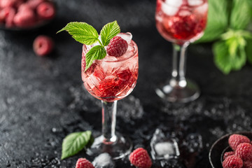 Fresh raspberry cocktail. Fresh summer cocktail with raspberry and ice cubes. Glass of raspberry...