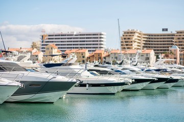 Fototapeta premium Marina with luxurious yachts and sailboats in touristic Vilamoura, Algarve, Portugal