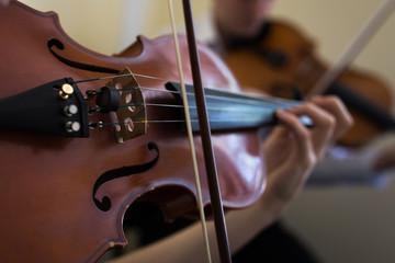 Girl playing the violin. Old violin close-up