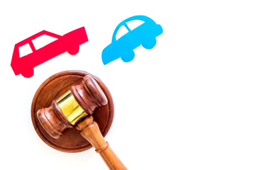 Car accident lawsuit concept. Two collided cars near judge gavel on white background top view copy...