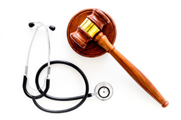 Medical law, health law concept. Gavel and stethoscope on white backgound top view copy space