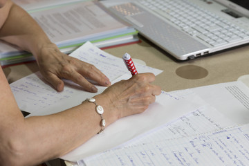 papers on the table, the pen and poking the computer