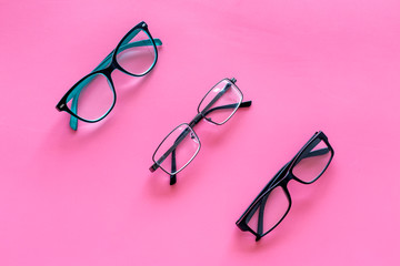 Glasses concept. Set of glasses with different eyeglass frame and transparent lenses on pink...