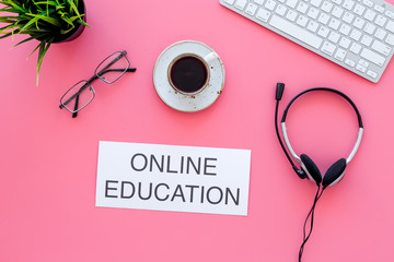 Get higher education distantly. Words online education on pink office work desk with computer...
