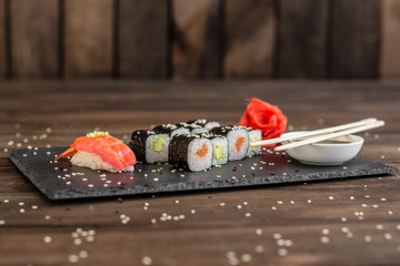 Fresh and tasty sushi on dark background. It can be used as a background
