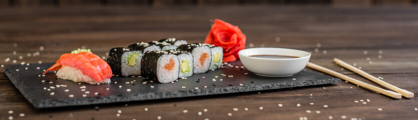 Fresh and tasty sushi on dark background. It can be used as a background