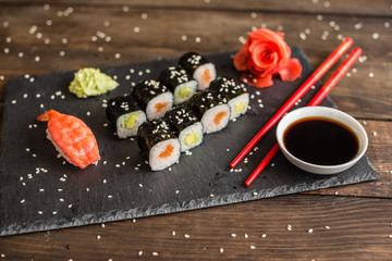 Fresh and tasty sushi on dark background. It can be used as a background