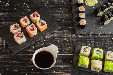 Fresh and tasty sushi on dark background. It can be used as a background