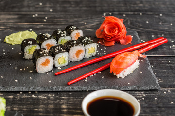 Fresh and tasty sushi on dark background. It can be used as a background